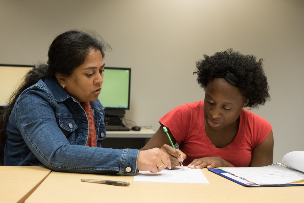 An adult learner works with a volunteer tutor at the Library. © steven e gross17919 Waukegan Public Library